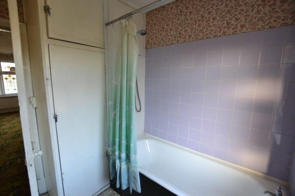 Original bathroom with purple tiles. 